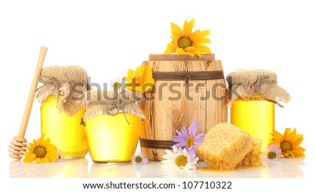 Sweet honey in jars and barrel with honeycomb, wooden drizzler and flowers isolated on white
