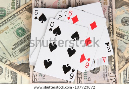 Dollars and a deck of playing cards close-up