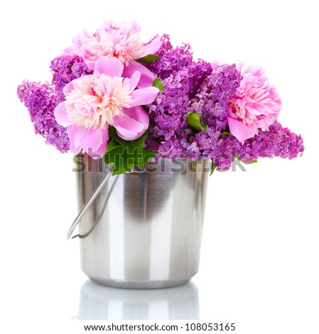 beautiful lilac and peonies flowers in metal bucket isolated on white