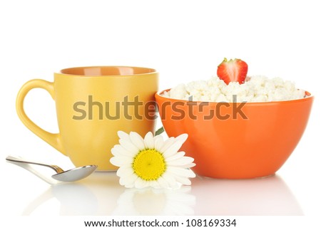 cottage cheese with strawberry in orange bowl and orange cup with coffee, spoon and flower isolated on white
