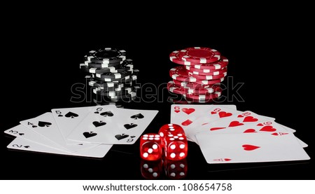 winning combination of playing cards with poker chips and dice on black background