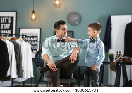 Stylish father and son in shirts, indoors