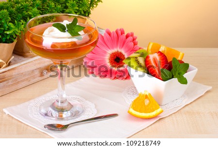 fruit jelly in glass and fruits on table in cafe