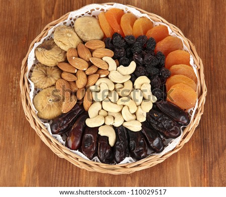 different dried fruits on wooden background