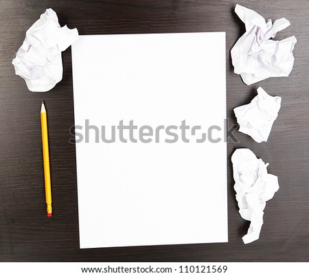 empty paper, crumpled paper and pencil on wooden table