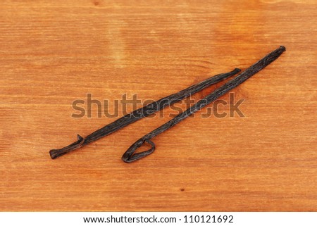 Vanilla pods on wooden background close-up