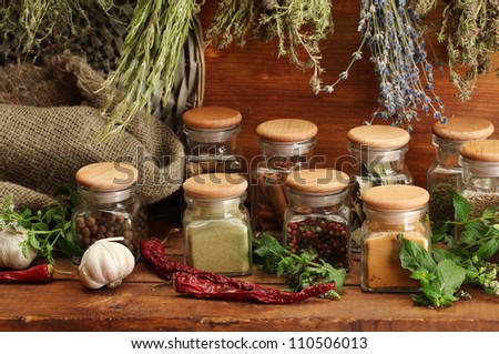 dried herbs, spices and and pepper, on wooden background