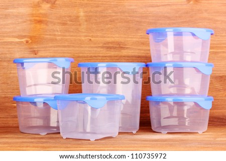 Plastic containers for food on wooden background