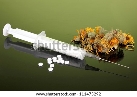 Traditional medicine against homeopathy, on green background