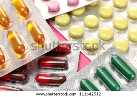 Capsules and pills packed in blisters, close up