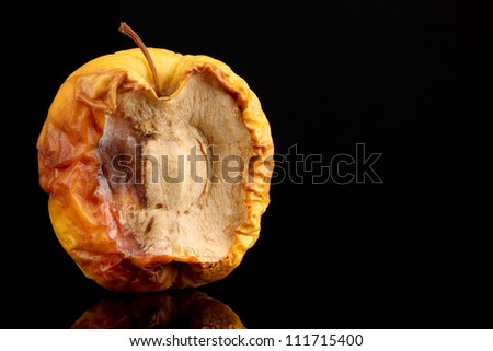 yellow moldy apple as concept of skin problems, isolated on black