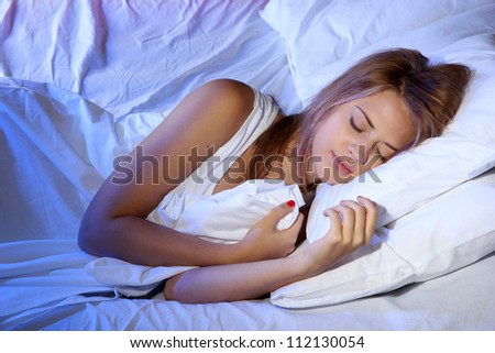 young beautiful woman sleeping on bed in bedroom