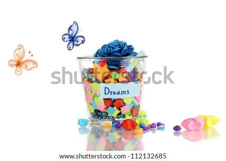 Glass vase with paper stars with dreams isolated on white