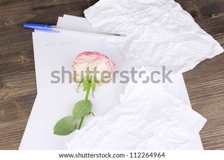 Creation of composition and crumpled sheets on wooden table