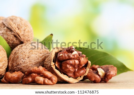 walnuts with green leaves, on green background