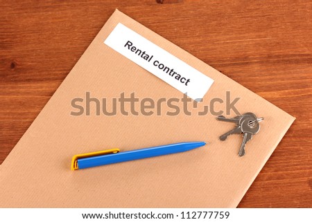Rental contract on wooden background close-up