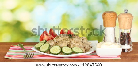 Delicious cooked dumplings with vegetables in the dish on bright green background