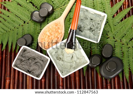 cosmetic clay for spa treatments on bamboo background close-up