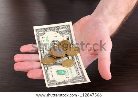Counting money in hand on wooden table background