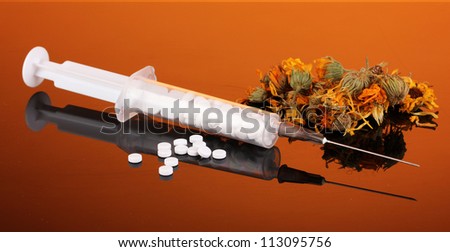Traditional medicine against homeopathy, on orange background