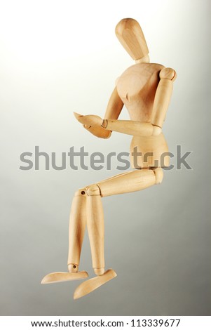wooden mannequin, on grey background