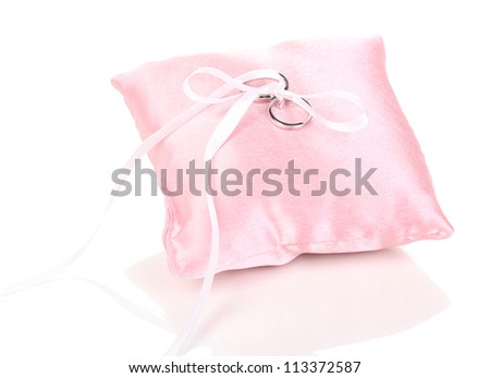 Wedding rings on satin pillow isolated on white