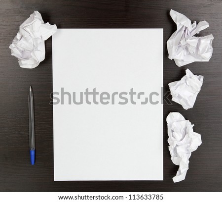 empty paper, crumpled paper and pen on wooden table