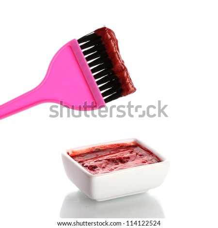 Bowl with red hair color and pink brush, on white background