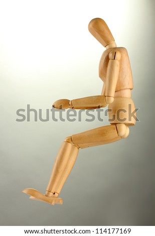 wooden mannequin, on grey background