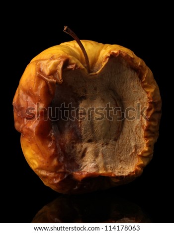 yellow moldy apple as concept of skin problems, isolated on black