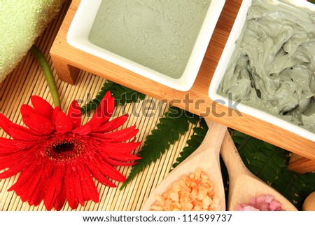 cosmetic clay for spa treatments on straw background close-up