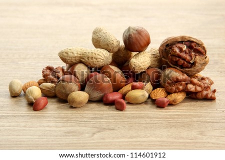 assortment of tasty nuts on wooden background