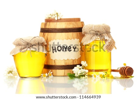 Sweet honey in barrel and jars with acacia flowers isolated on white