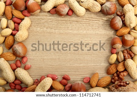 assortment of tasty nuts on wooden background