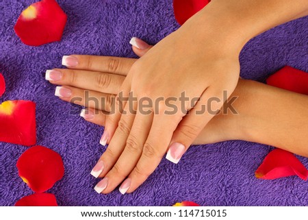 woman\'s hands on purple terry towel, close-up