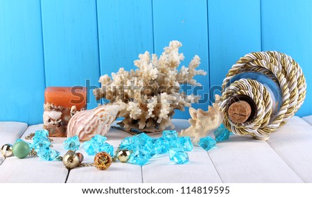 Decor of seashells on wooden table on blue wooden background