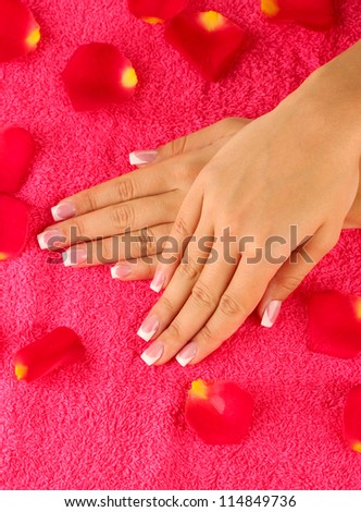 woman\'s hands on bright pink terry towel, close-up