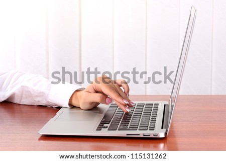business woman\'s hands typing on laptop computer, close-up