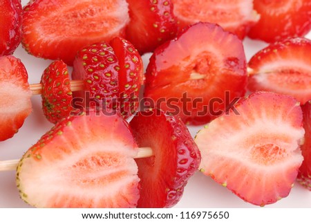 Sweet ripe strawberries on stick close-up