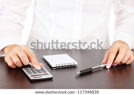 Woman\'s hands counts on the calculator, close-up