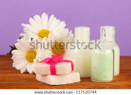 ingredients for soap making on violet background