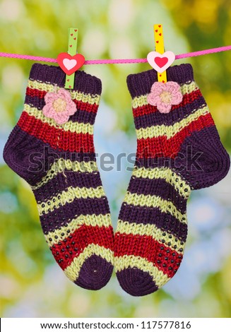 Pair of knit striped socks hanging to dry