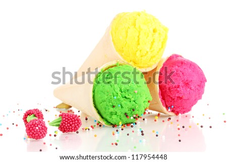 Three scoops of lemon, strawberry and kiwi ice cream in the waffle cones decorated with sprinkles