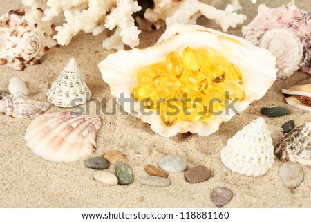 fish oil in the shell on the sand. idea of sea gifts