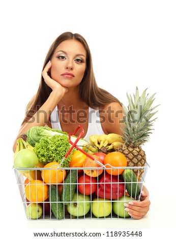 beautiful young woman with fruits and vegetables in shopping basket, isolated on white