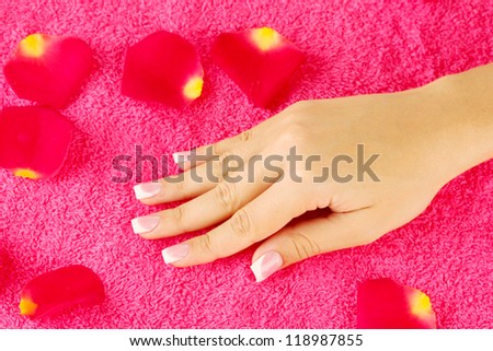 woman\'s hand on bright pink terry towel, close-up