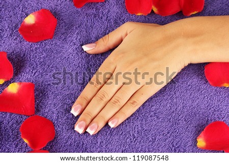 woman\'s hand on purple terry towel, close-up