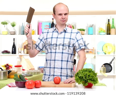 The young man in kitchen preparing