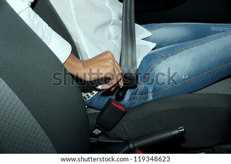 driver fastening seat belt in car