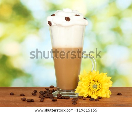 glass of fresh coffee cocktail on green background
